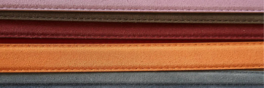 Layers of leather fabric in various colors highlighting the stitching and quality of the material.