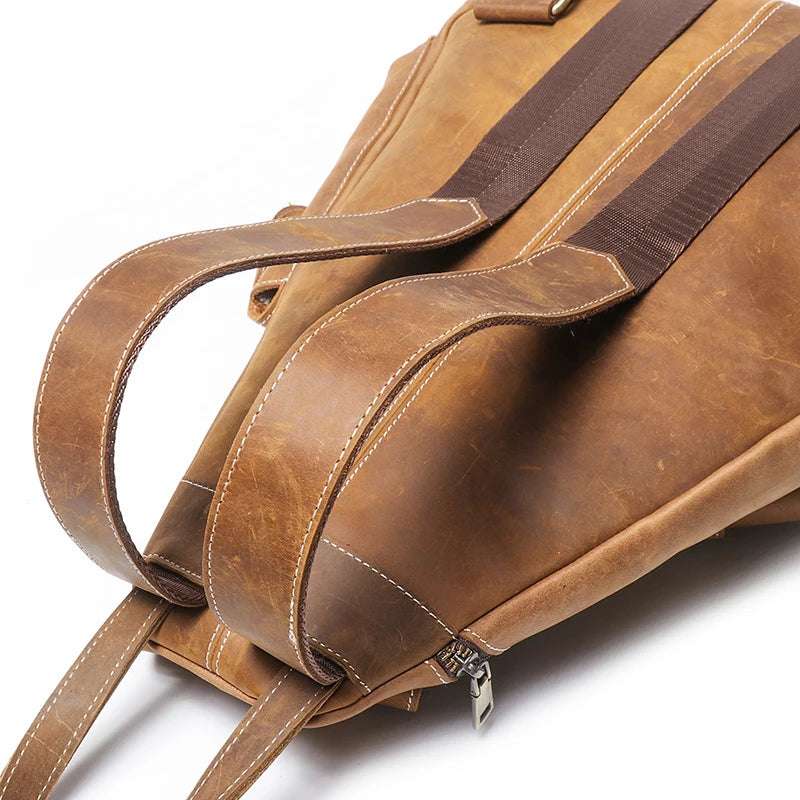 Close-up of a vintage leather backpack showcasing its straps and texture.