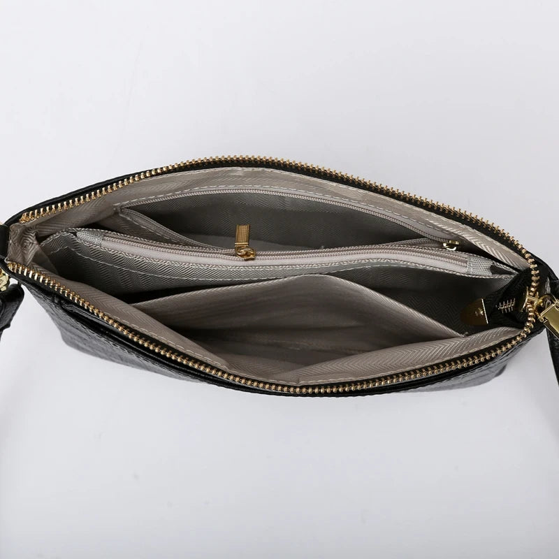 Interior view of a black bag, showing multiple compartments and zipper closure. Great option for organizing essential items.
