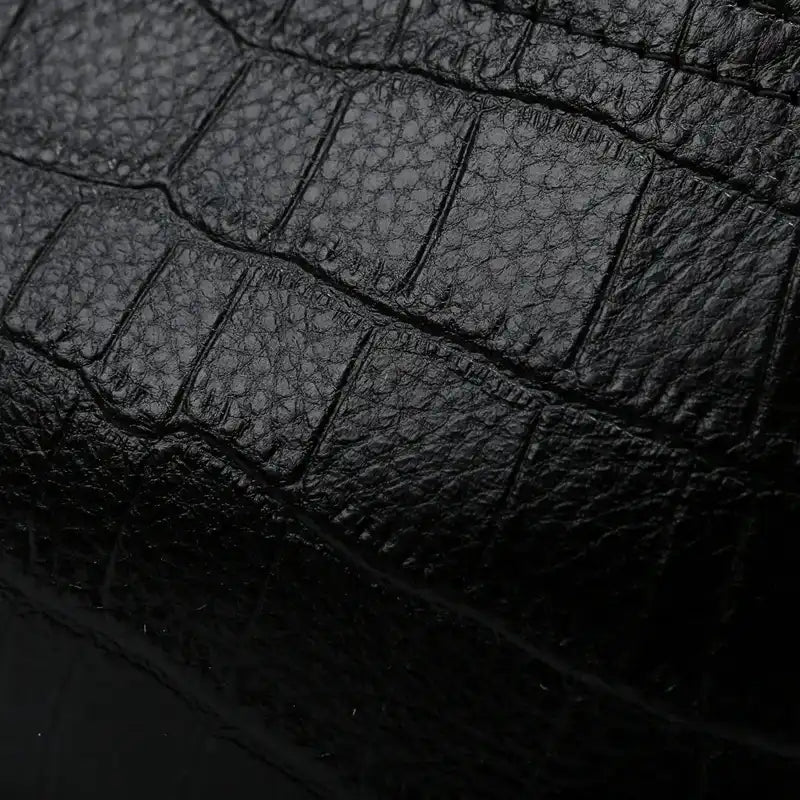 Black crocodile leather texture, highlighting the unique patterns and sophistication of the material.