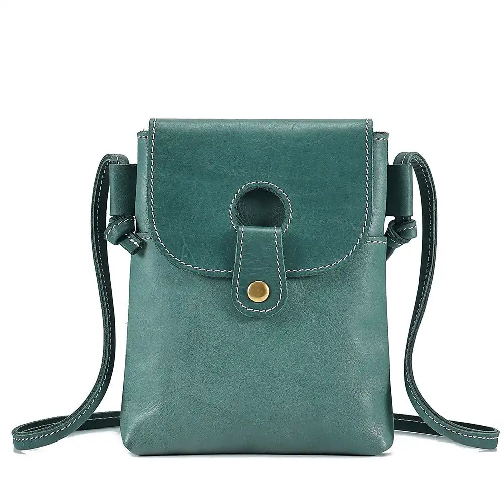 light blue women's leather crossbody bag, with long handle and elegant clasp - front view.