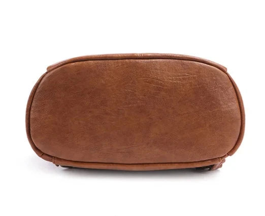 Bottom view of a brown leather bag showcasing its smooth texture.