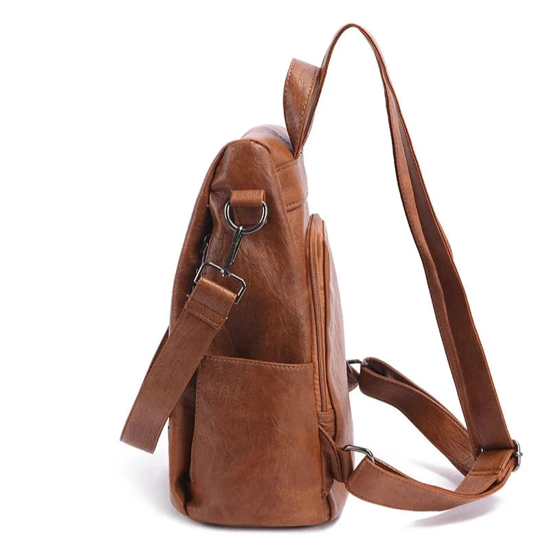 Chic brown leather backpack with a sleek design and comfortable handle and straps - side view