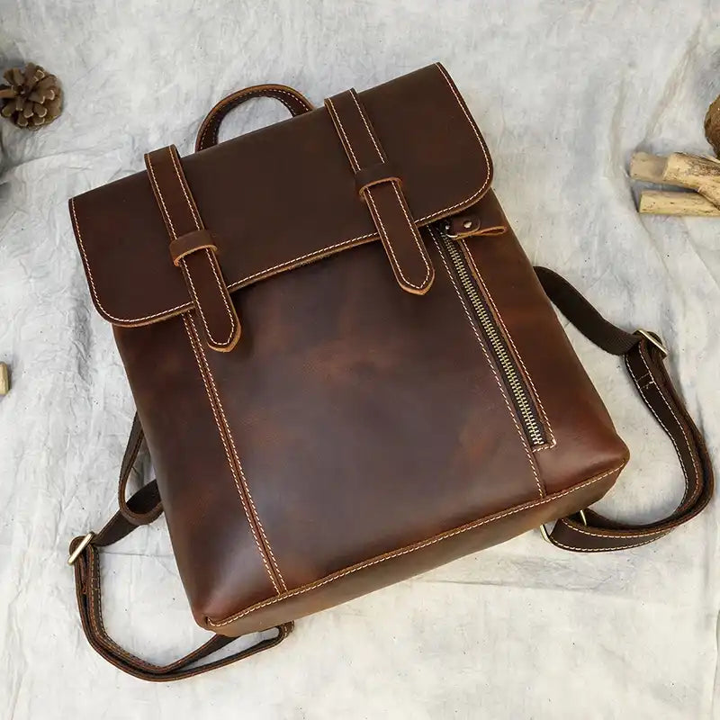 Brown leather backpack with an elegant design features detailed stitching and functional compartments.
