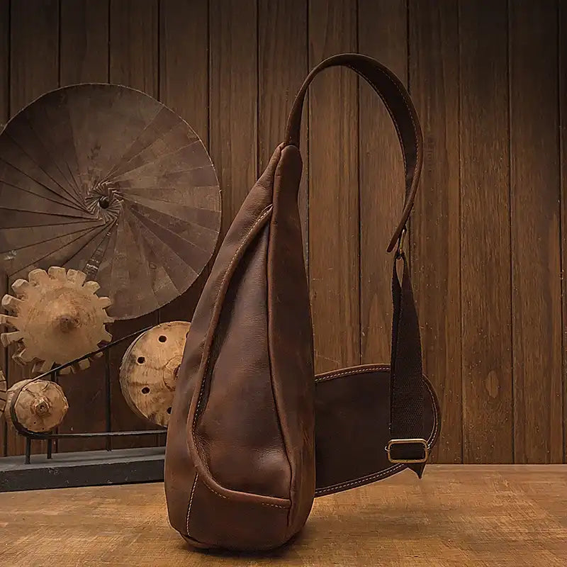 Vintage-style leather sling bag showcasing craftsmanship and design - side view.