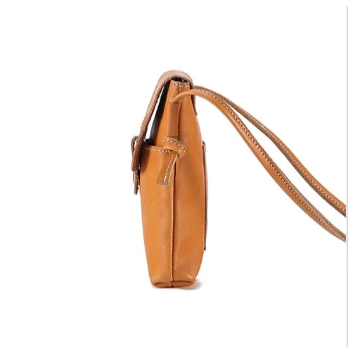 Brown women's leather crossbody bag, with long handle and elegant design - side view.