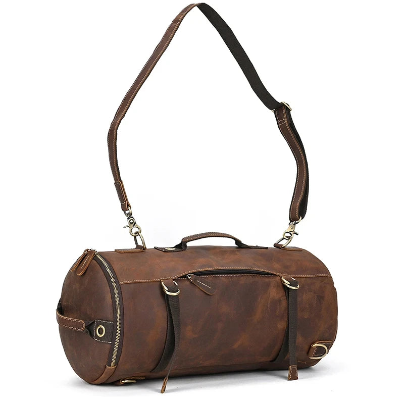 Brown leather duffle bag, with removable long strap and modern design, front view.