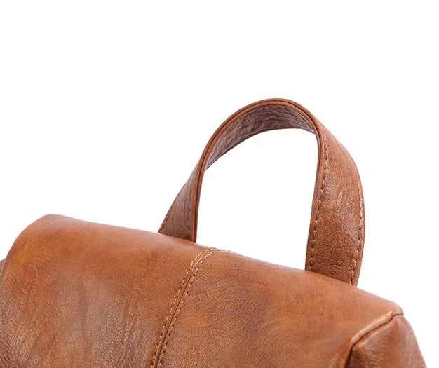 Detailed shot of a brown leather bag showcasing its soft handle.