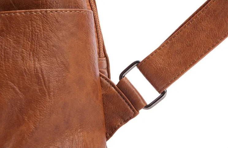 Detailed image of a stylish brown leather bag showcasing the strap attachment.