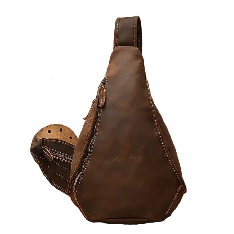 Brown leather sling bag on a white background, front view.