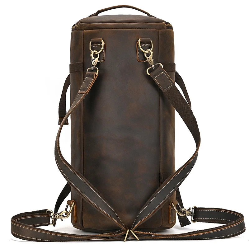High quality dark brown leather duffle bag with adjustable straps and metal details, back view.