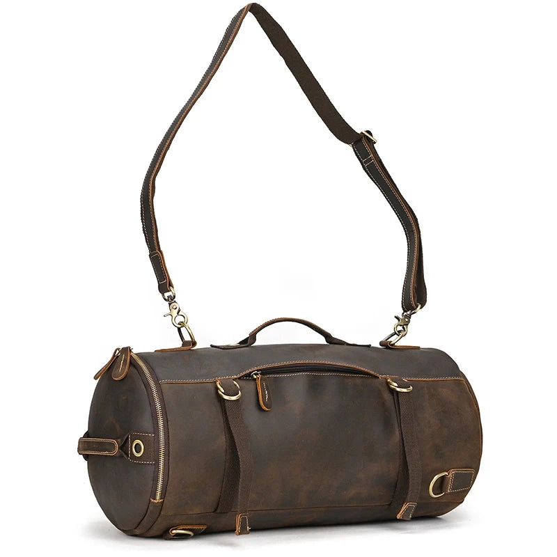 Dark brown leather duffle bag, with removable long strap and modern design, front view.
