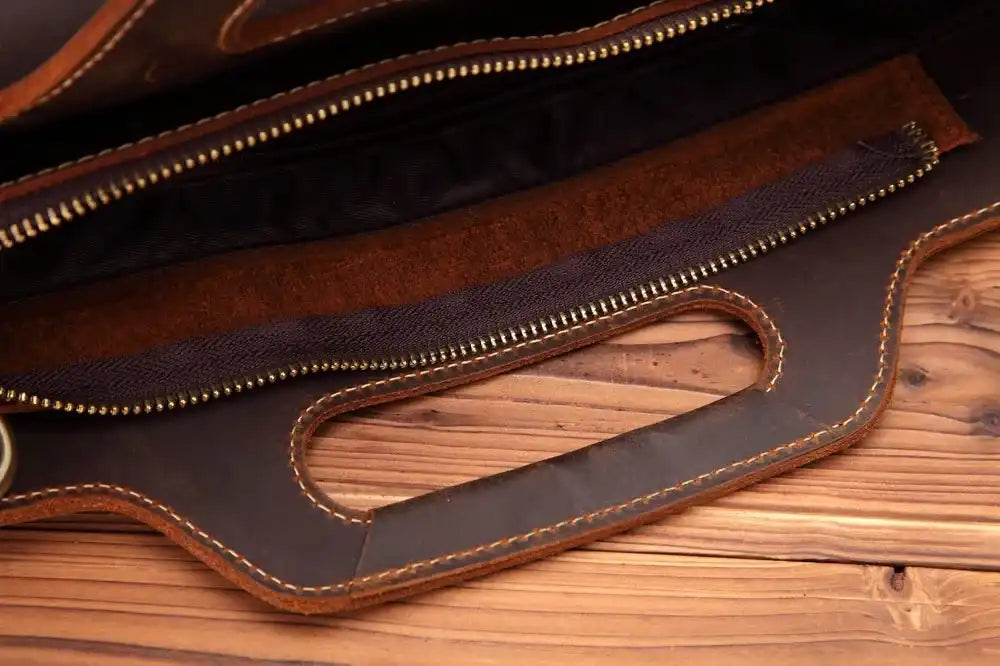 Close-up of the interior of a leather zippered bag highlighting the quality of the material and the careful craftsmanship.