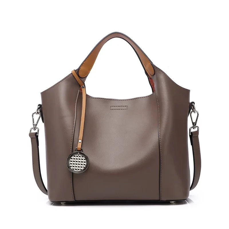 Khaki leather bag with soft detachable handles and elegant charm, front view - variant.