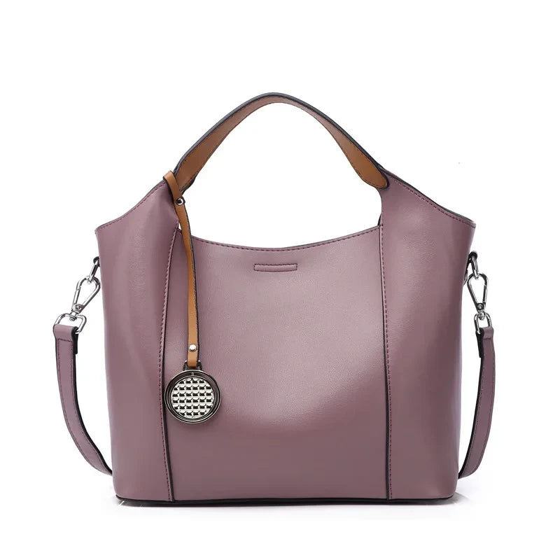Purple leather bag with soft detachable handles and elegant charm, front view - variant.