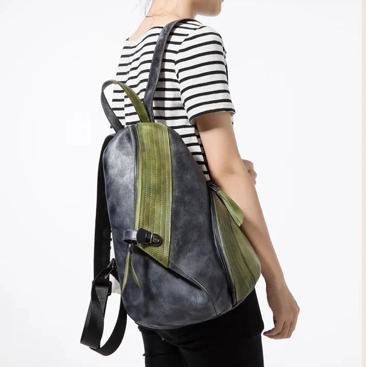 Modern patchwork backpack in green & black worn by a woman, showcasing a chic design.