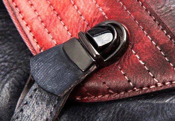 Detail of a leather clasp, highlighting the stitching on a leather bag.