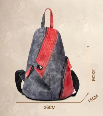A stylish patchwork leather backpack in black and red with dimensions 26cm x 15cm x 32cm.
