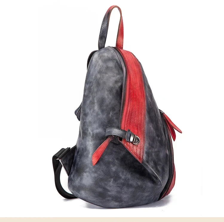 A modern backpack featuring a unique patchwork design with a red and black accent.