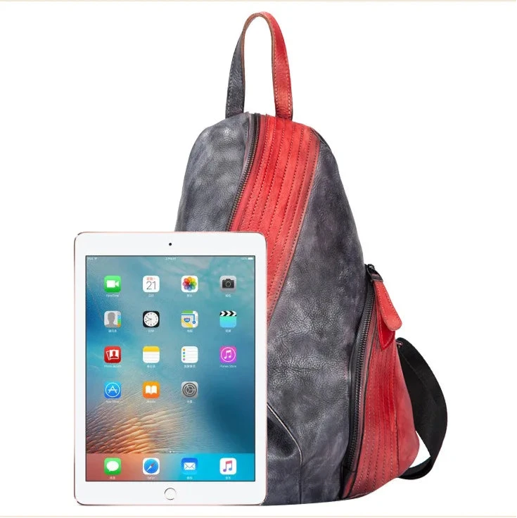 Modern leather backpack in black and red with an iPad for size compaison.