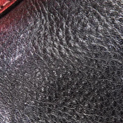 detailed view of a genuine black leather surface with natural grain.