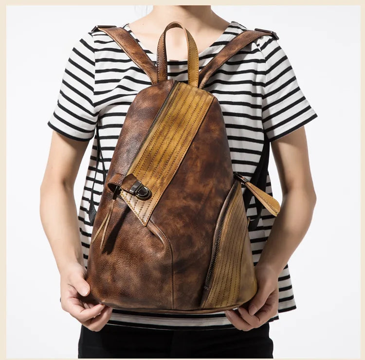 Modern patchwork backpack in yellow & brown worn by a woman, showcasing a chic design.