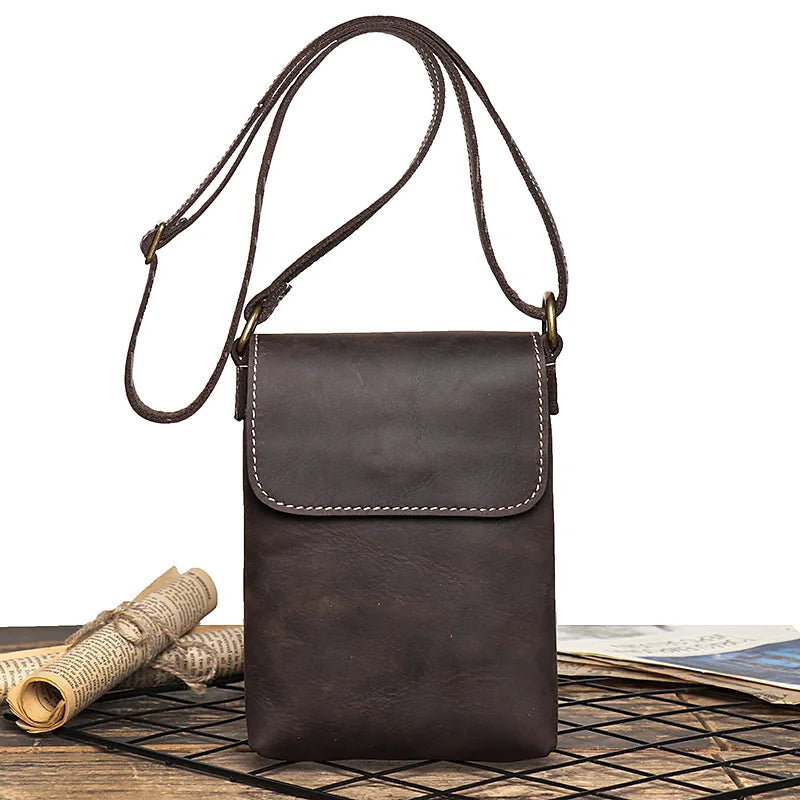 Vintage dark brown leather mini shoulder bag with adjustable strap - front view