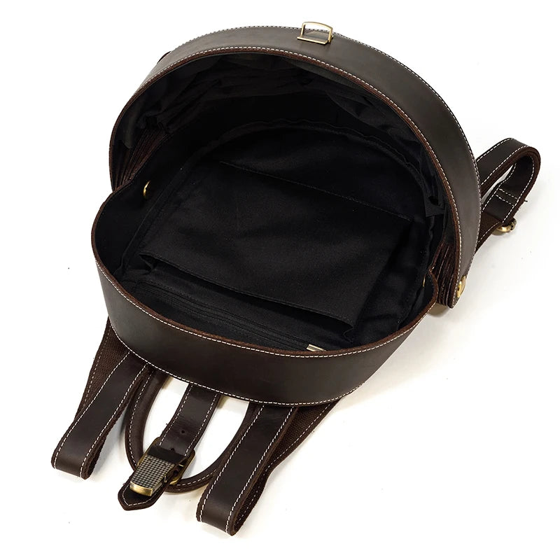 Open dark brown leather backpack with black interior lining showcasing large capacity.