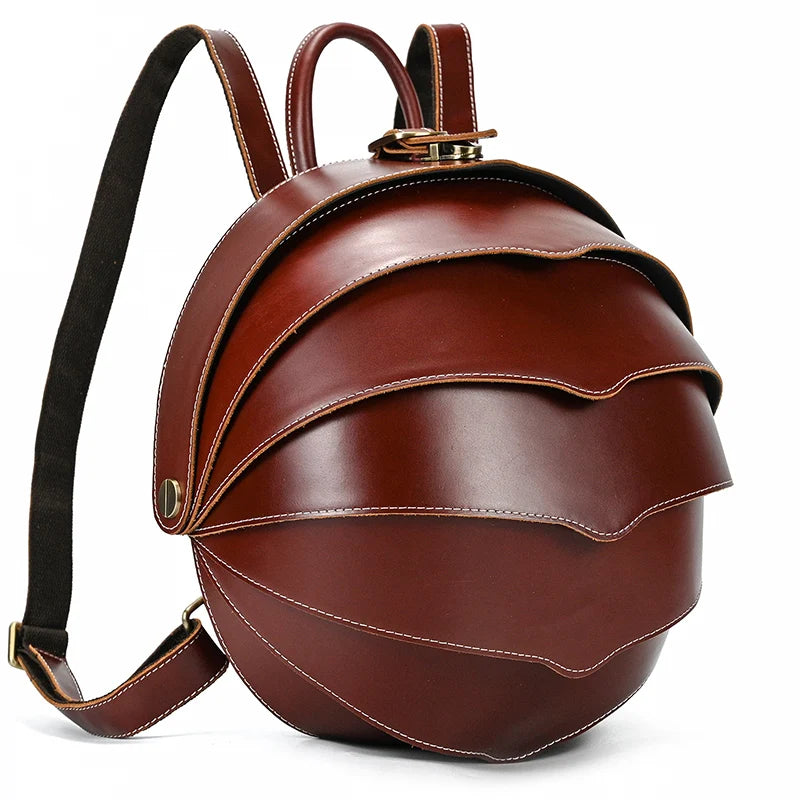 Brown tone leather backpack with an exclusive wavy design, highlighting its elegant stitching and rounded shape, front view.
