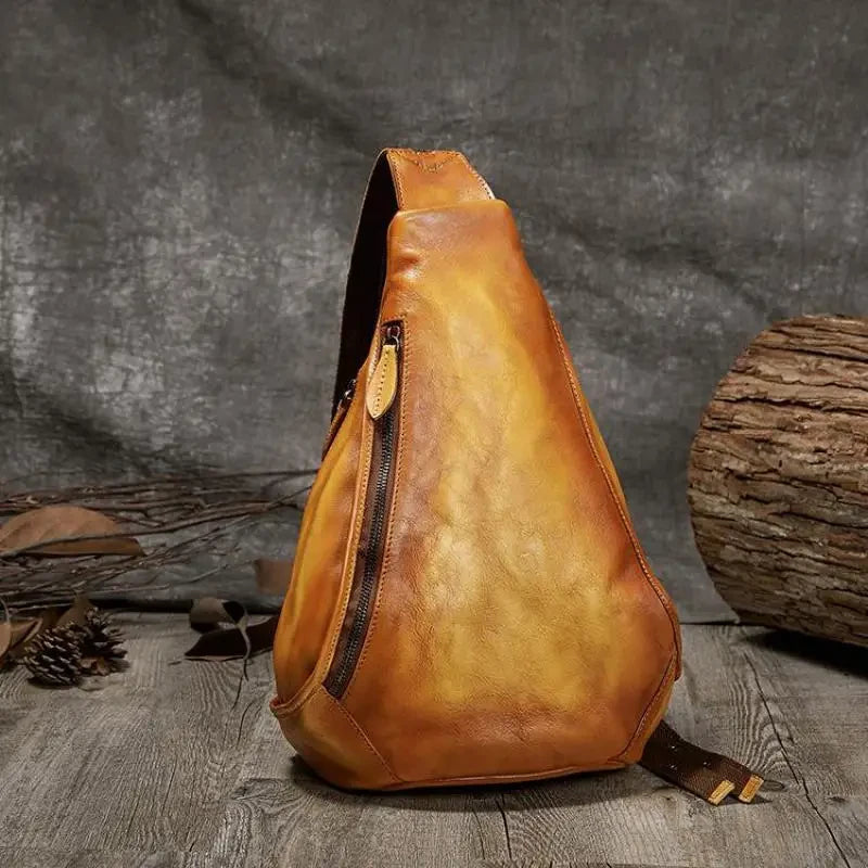 vintage yellow leather shoulder bag with a unique triangular design - front view.