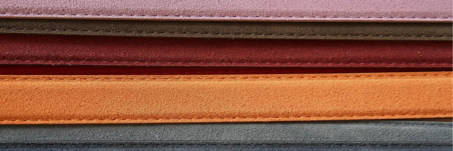 Layers of leather fabric in various colors highlighting the stitching and quality of the material.