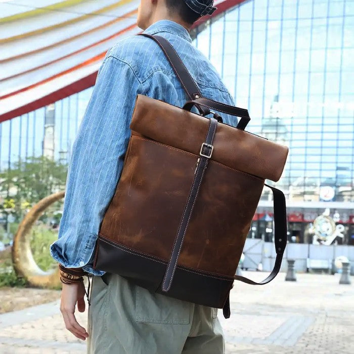 Man wearing a leather backpack on his shoulder