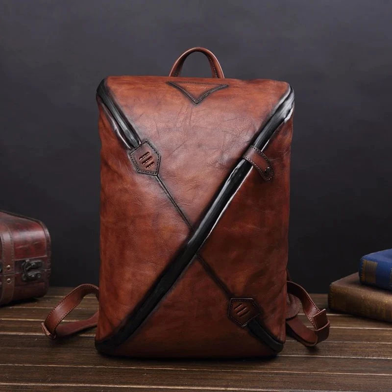 Stylish coffee brown vintage leather backpack with unique design, soft handle and adjustable straps, front view.
