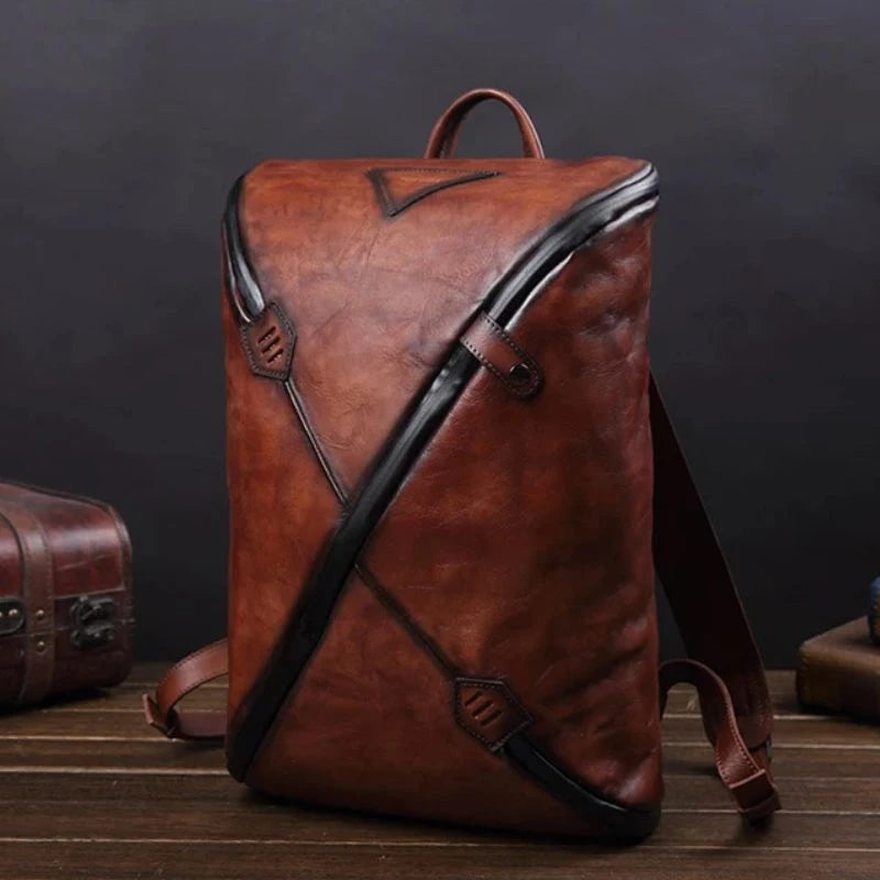 coffee brown vintage leather backpack with unique design, soft handle and adjustable straps, front view.