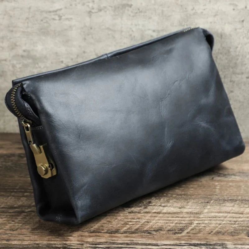 Blue leather makeup bag with zipper and lock details.