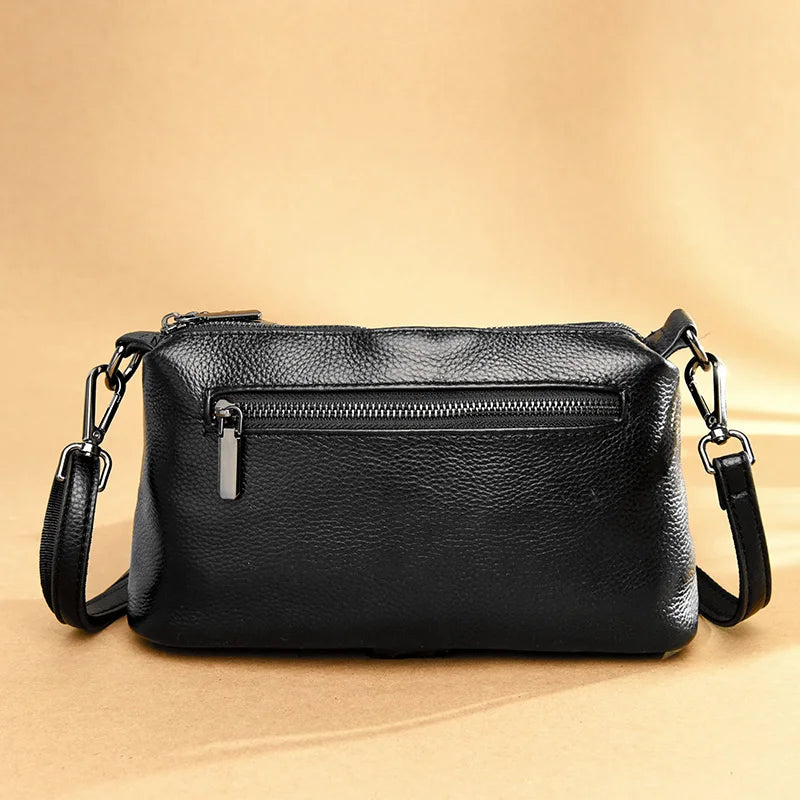 Chic Genuine Leather Shoulder Bag  with zippered compartments and metal hardware.