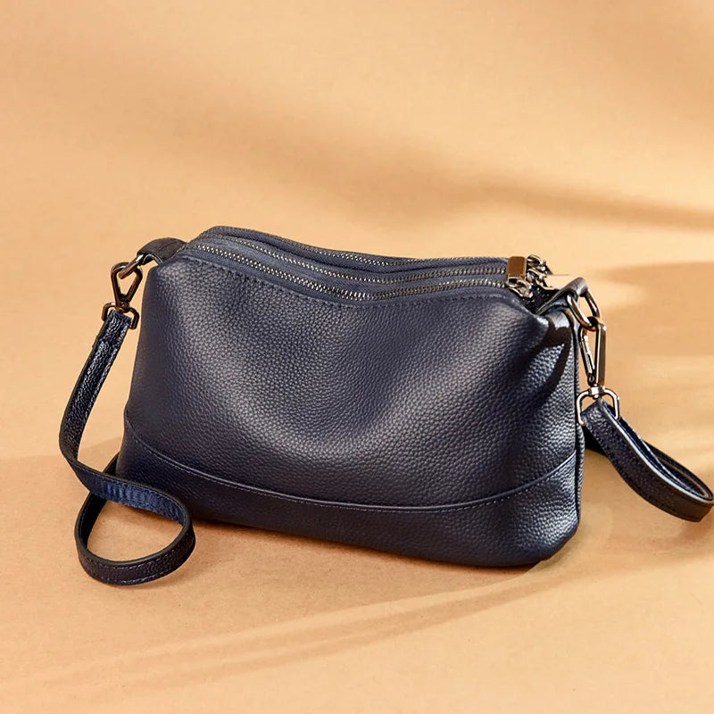 Chic Genuine Leather Shoulder Bag, featuring three zippered compartments and an adjustable strap.