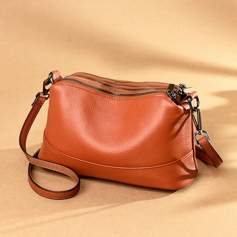 Chic Genuine Leather Shoulder Bag, featuring three zippered compartments and an adjustable strap.