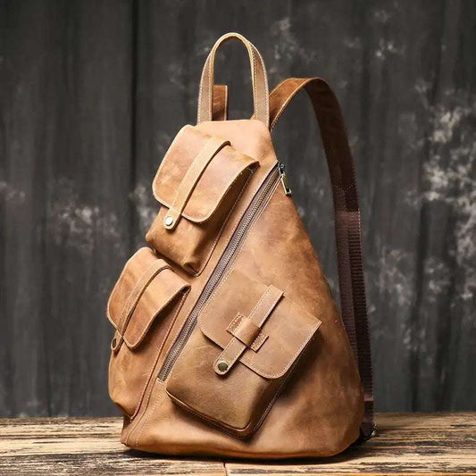 Vintage men's leather backpack with  pockets, diagonal zipper, and adjustable straps - front view