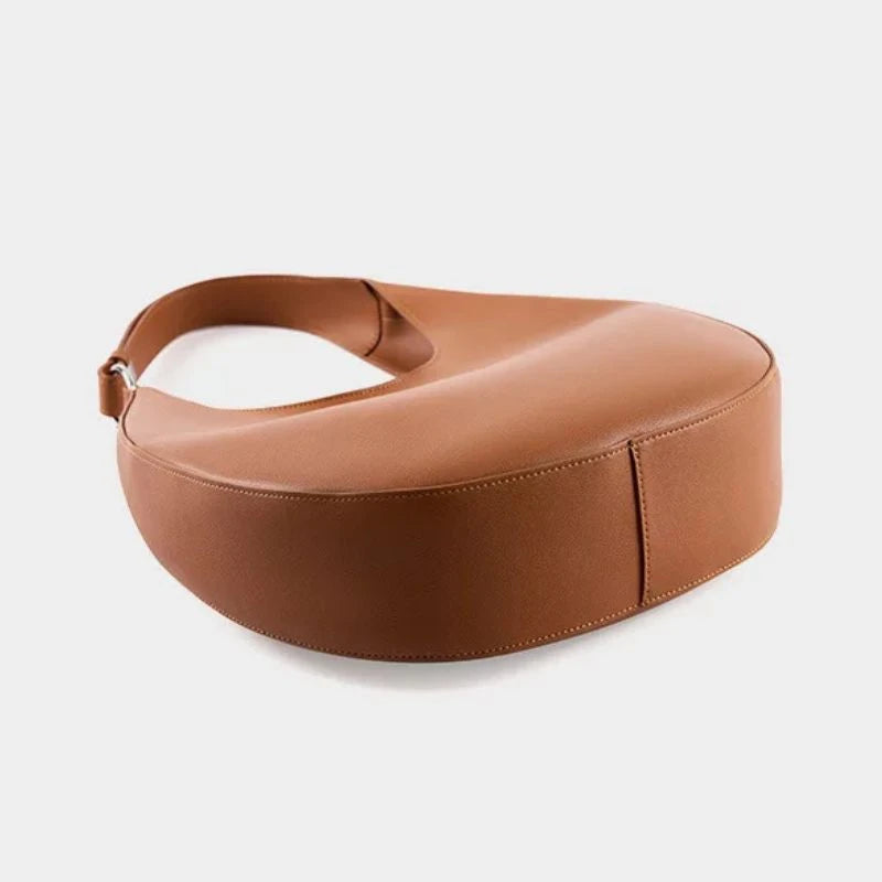 elegant brown leather bag, with a moon design and adjustable strap, bottom view