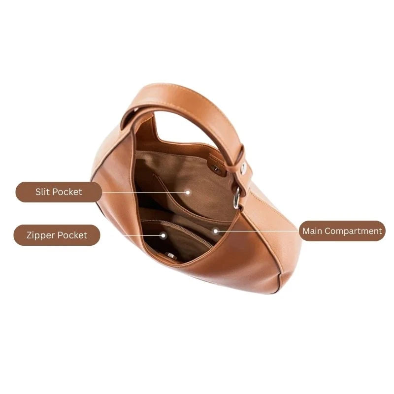 Interior view of a brown leather bag showing the main compartment and interior pockets.