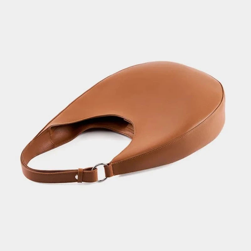 elegant brown leather bag, with a moon design and adjustable strap, top view