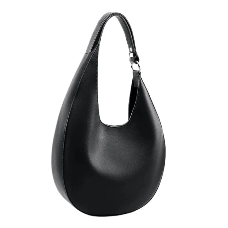 elegant black leather bag, with a moon design and adjustable strap, front view.