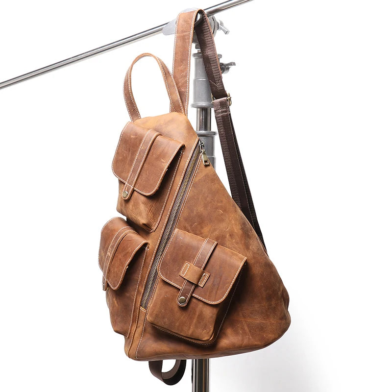Vintage brown leather backpack with buckle pockets, adjustable straps & distressed finish. Spacious, rugged & timeless design – front view