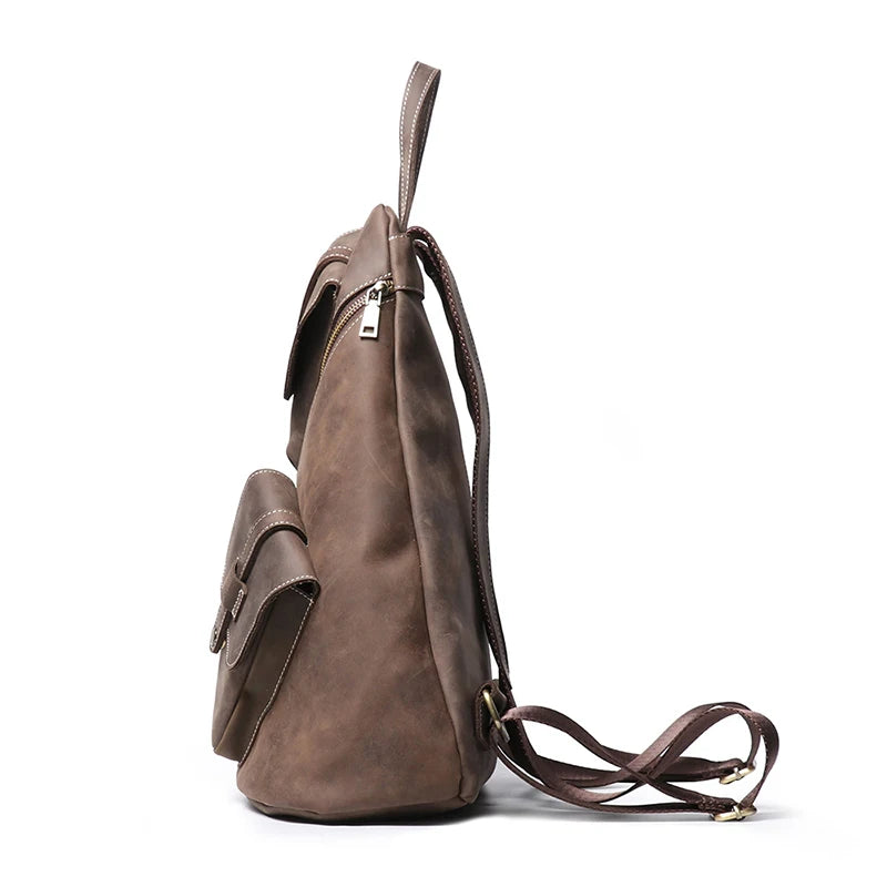 Side view of a stylish dark brown leather backpack with a zipper and front pocket.
