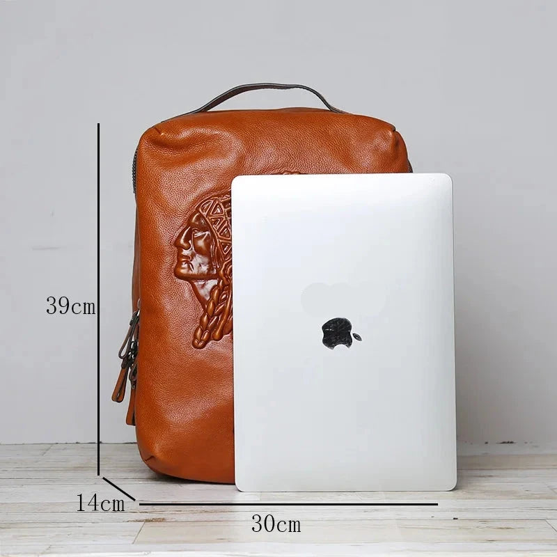 Brown leather backpack with embossed design, measuring 39cm by 30cm, next to a laptop for size reference.