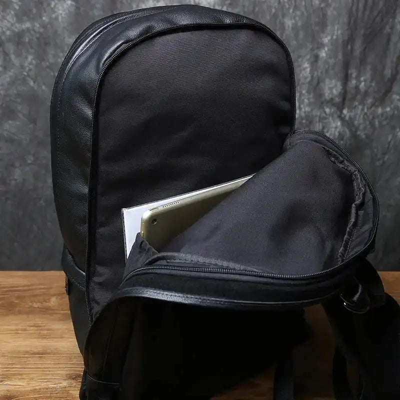 Modern design black backpack with laptop compartment and leather details, ideal for daily use and travel.