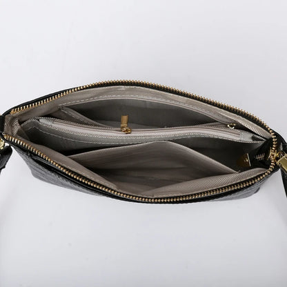 Interior view of a black bag, showing multiple compartments and zipper closure. Great option for organizing essential items.