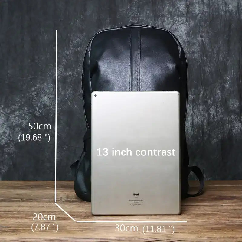 Black leather backpack next to a 13-inch iPad for size reference showing dimensions of 30cm wide, 50cm high, 20cm deep.