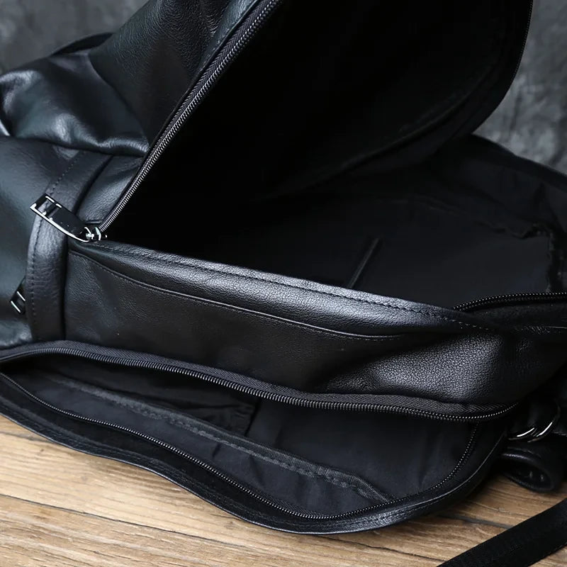 Interior view of a black leather backpack, highlighting the details of the zipper and the elegant material.